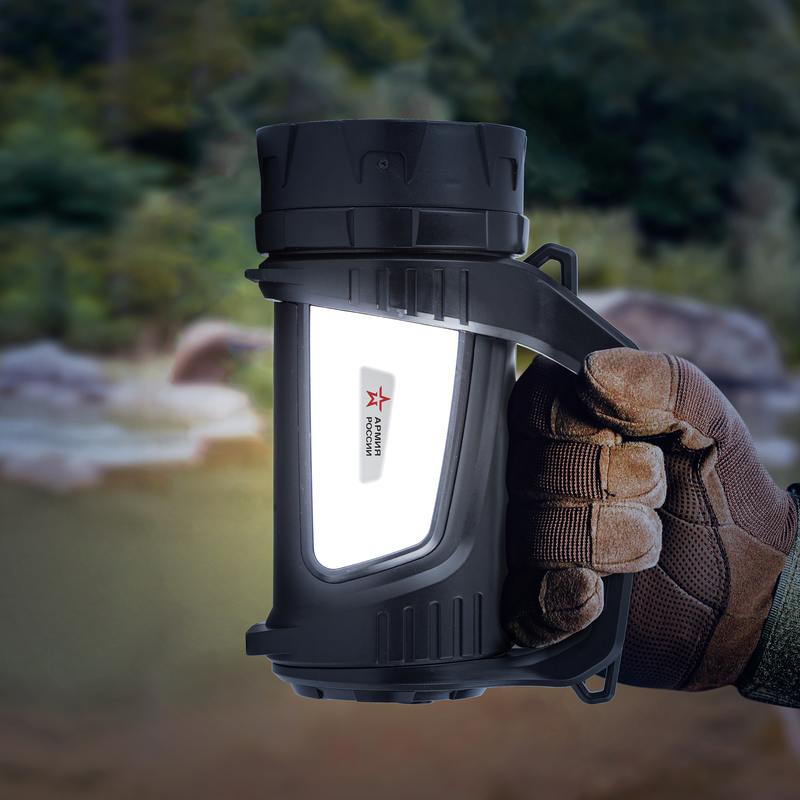 Photo of soldier hand in glove holding tactical thermos on nature background.